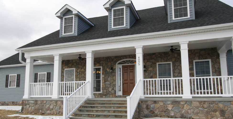 Beautiful traditional styling, from the raised front, stone and colonial blue siding.